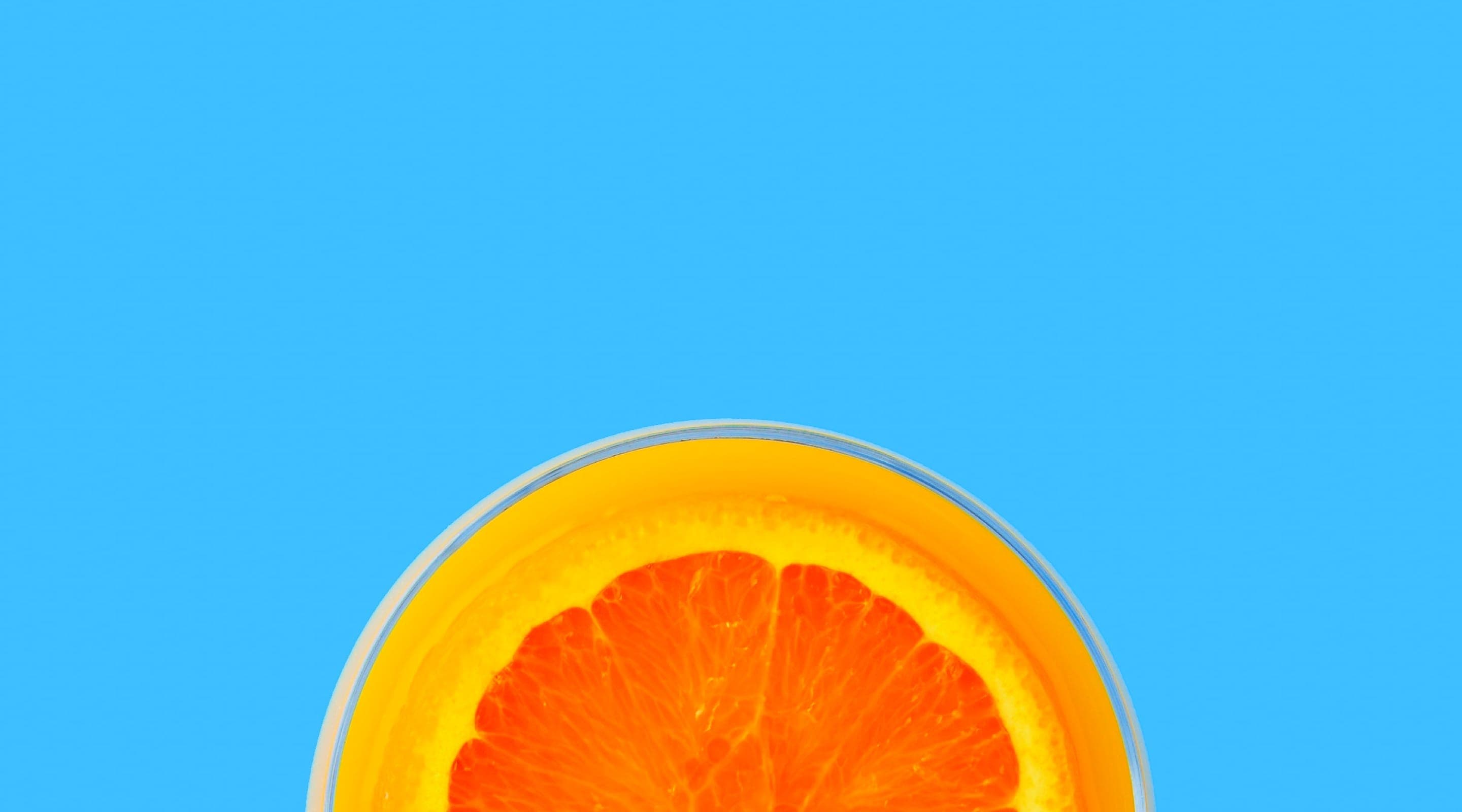 Half cut orange on a blue background